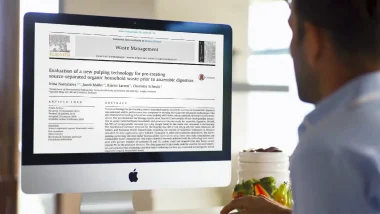 Image of man viewing a food waste separator research paper.